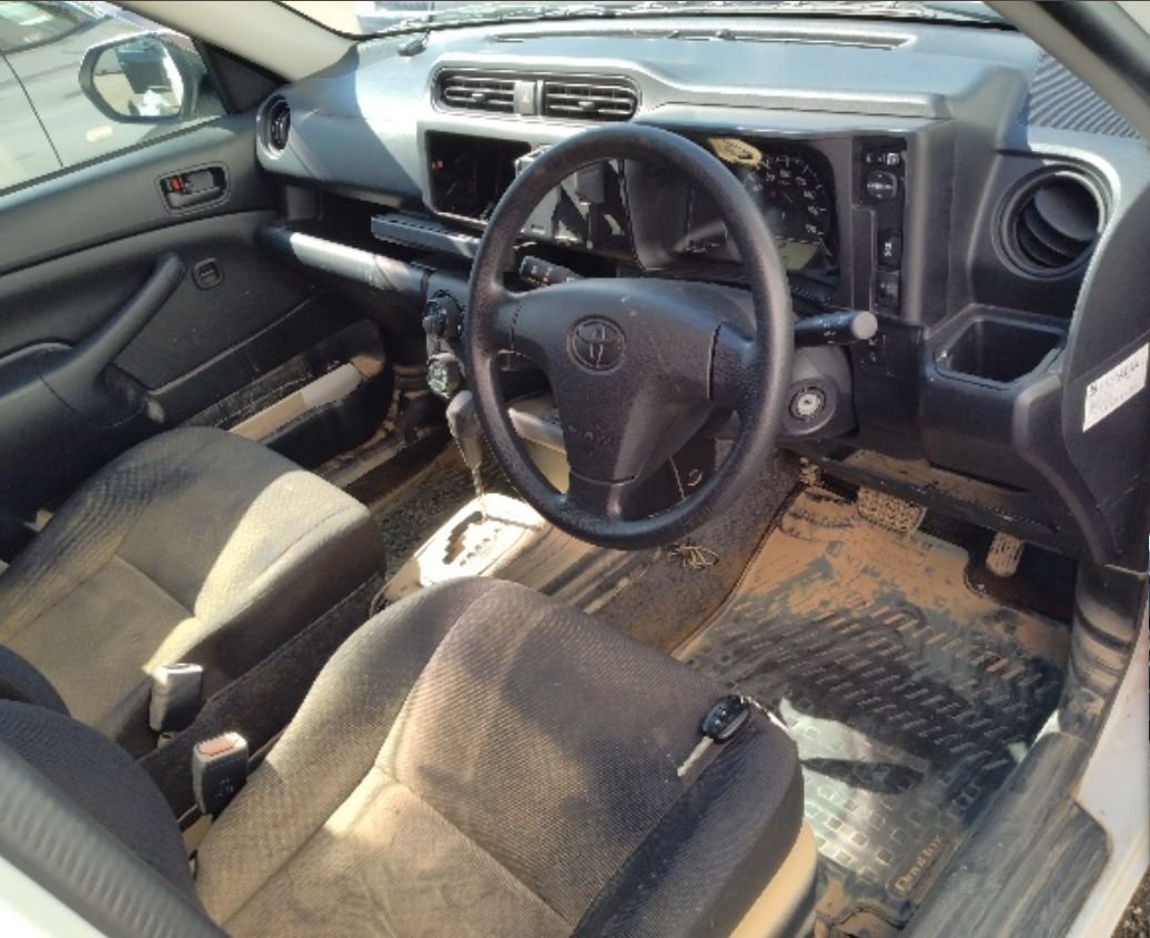 Right-hand-drive interior with mud on the floor and seats