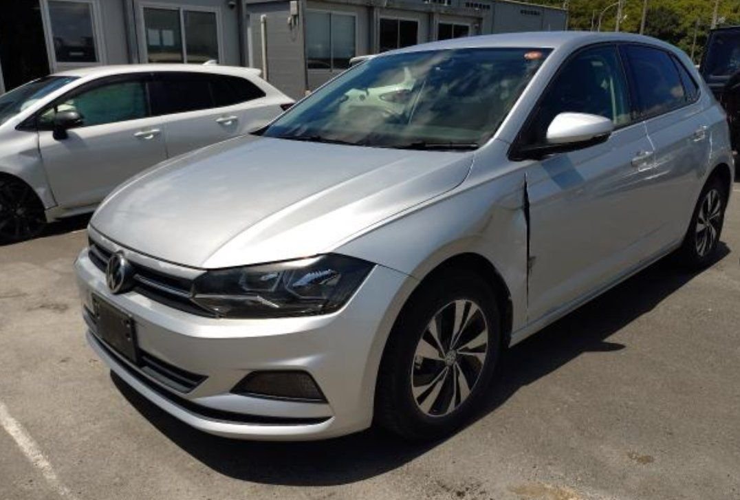 Silver Volkswagen Polo seen from the front left, showing the dented left front wing