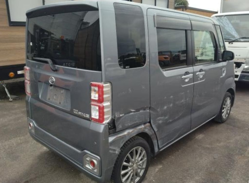 Rear right of the Daihatsu Wake showing the side-swipe damage