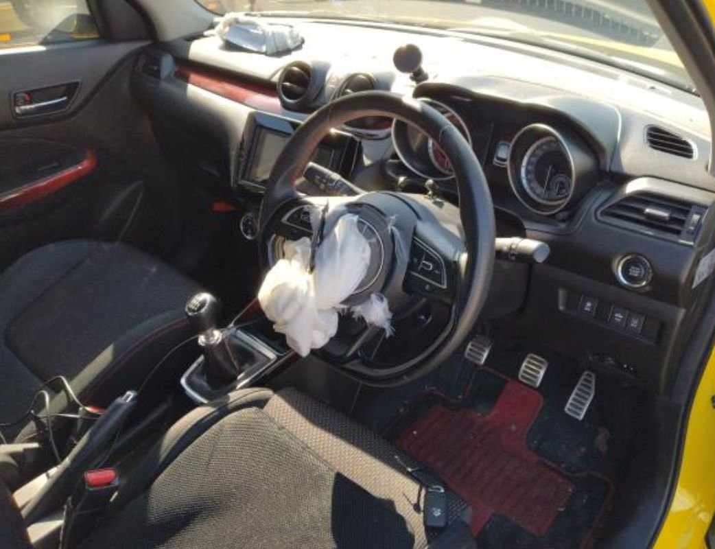 Right-hand-drive interior with manual gear lever and a deployed steering-wheel airbag