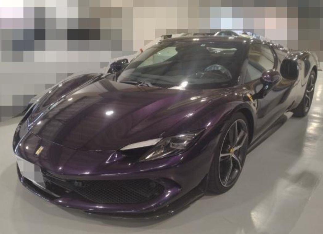 Purple Ferrari 296 GTB seen from the front left