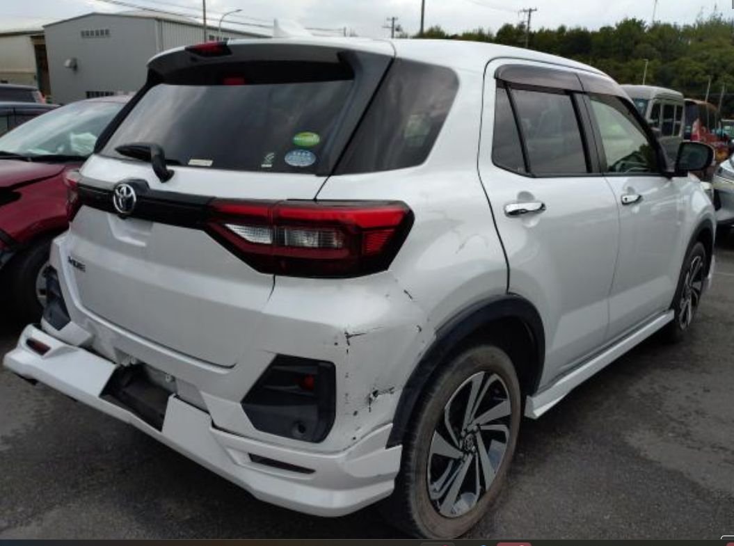 Rear right of the Raize showing rear bumper and quarter panel damage