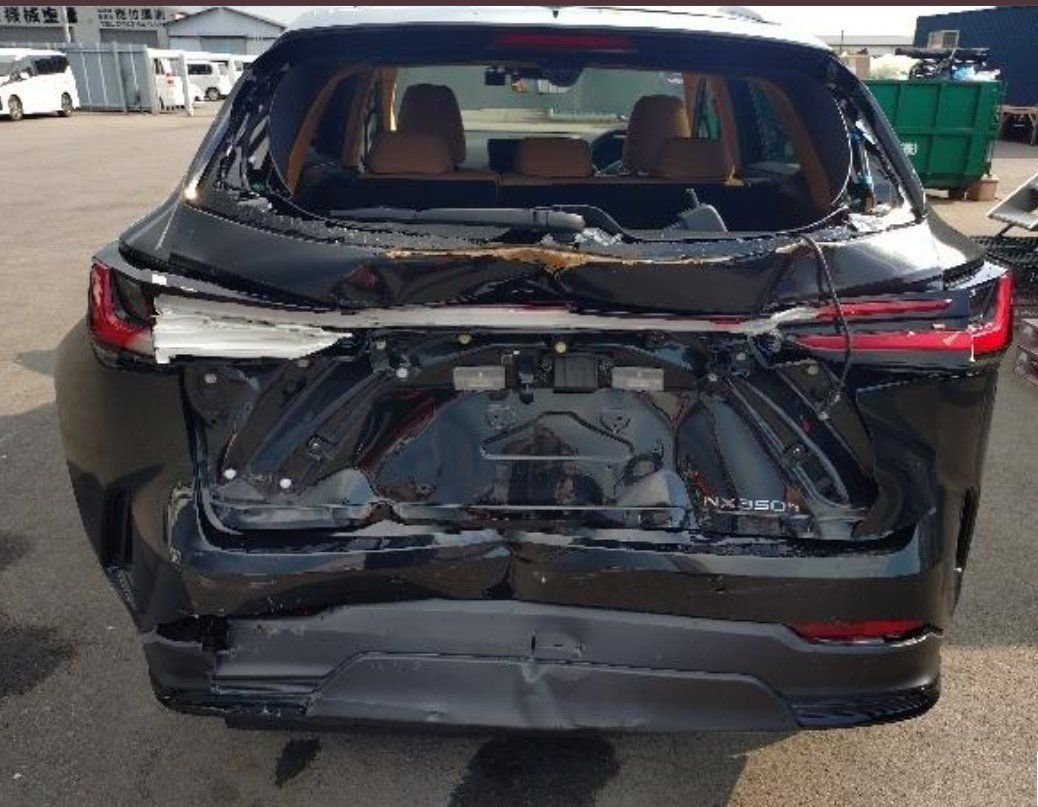 Rear view showing the collision damage to tailgate, glass and bumper
