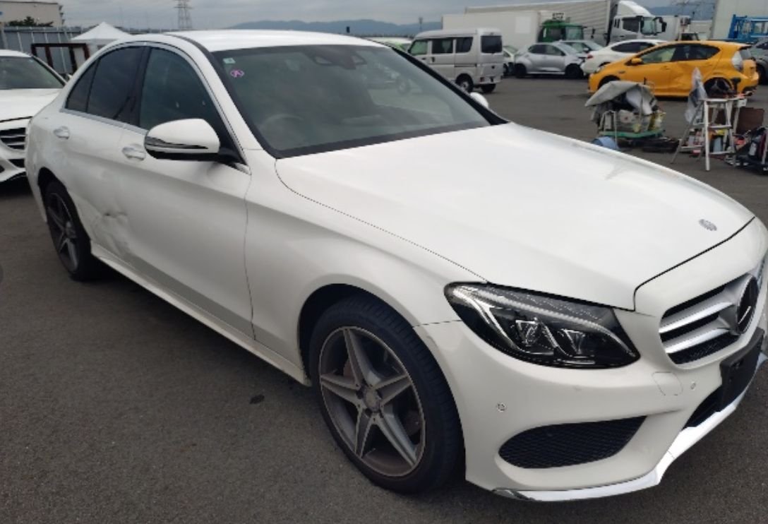 Front right of the C220d showing side-swipe damage on the right rear door