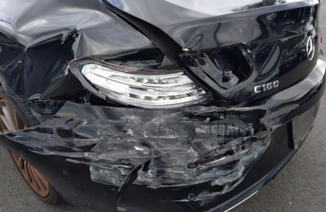 Close-up of the left rear impact damage around the tail lamp