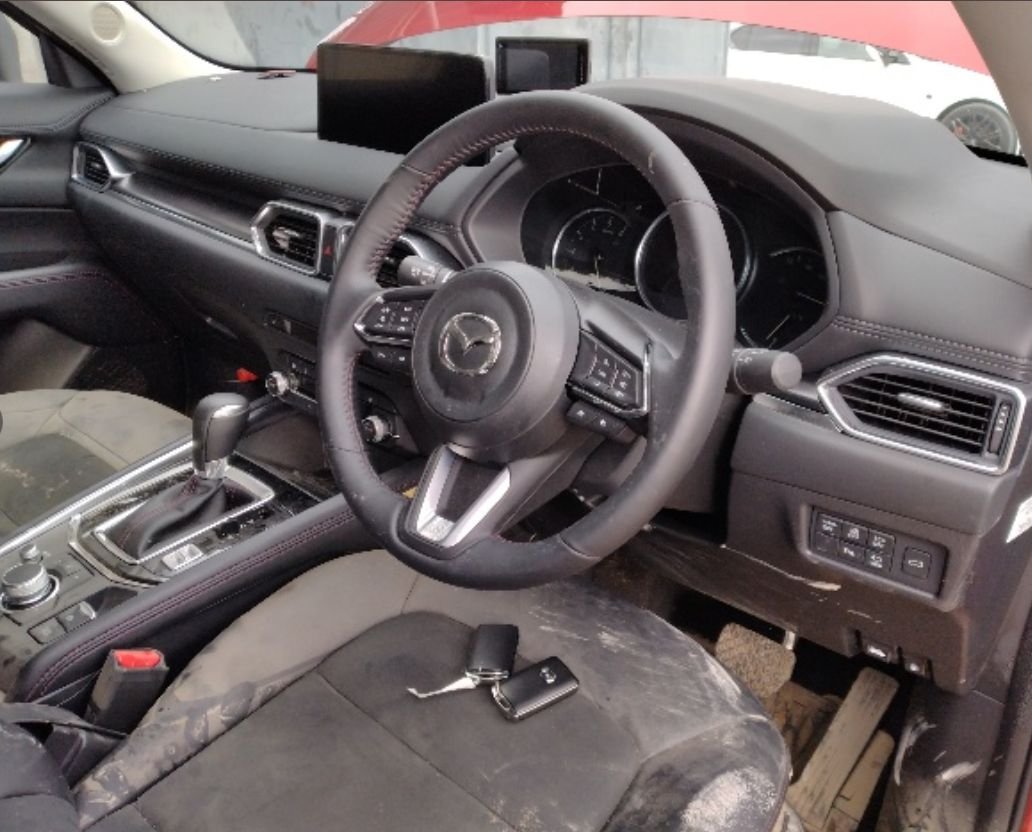 Right-hand-drive interior with dirt on the seats and floor