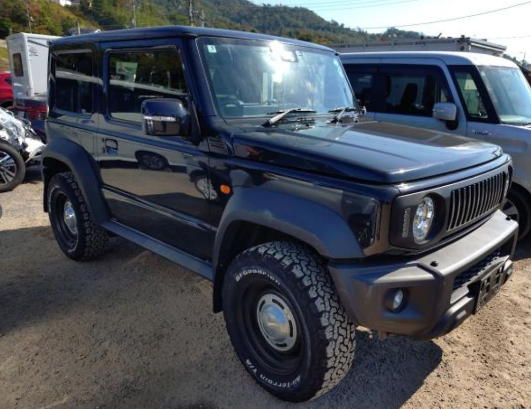 Black Suzuki Jimny Sierra with all-terrain tyres seen from the front