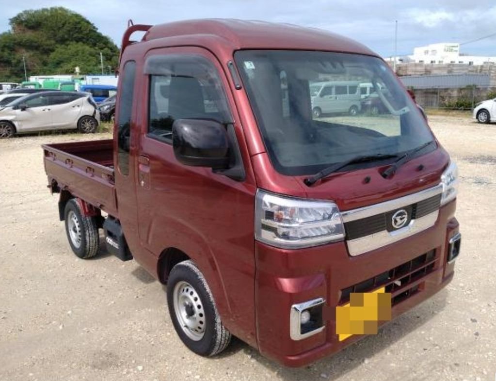 Red Daihatsu Hijet kei truck seen from the front right