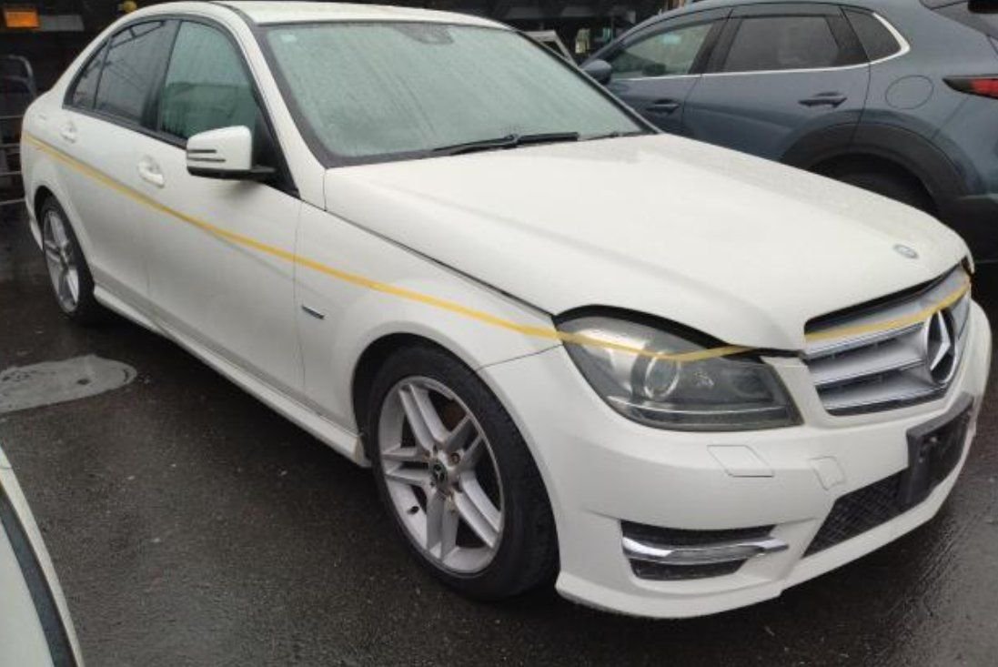White Mercedes-Benz C-Class sedan seen from the front right