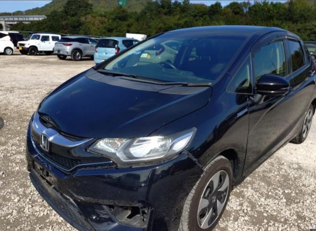 Black Honda Fit Hybrid seen from the front left with front bumper damage