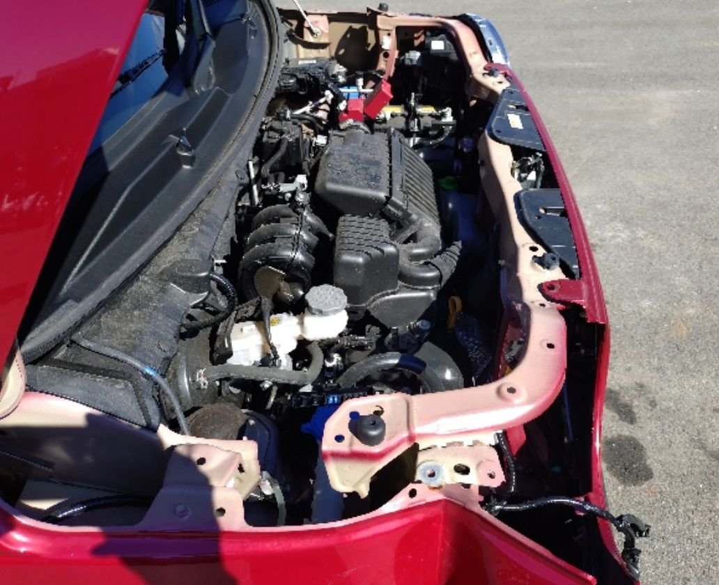 Engine bay with the front frame exposed and a cut wiring harness
